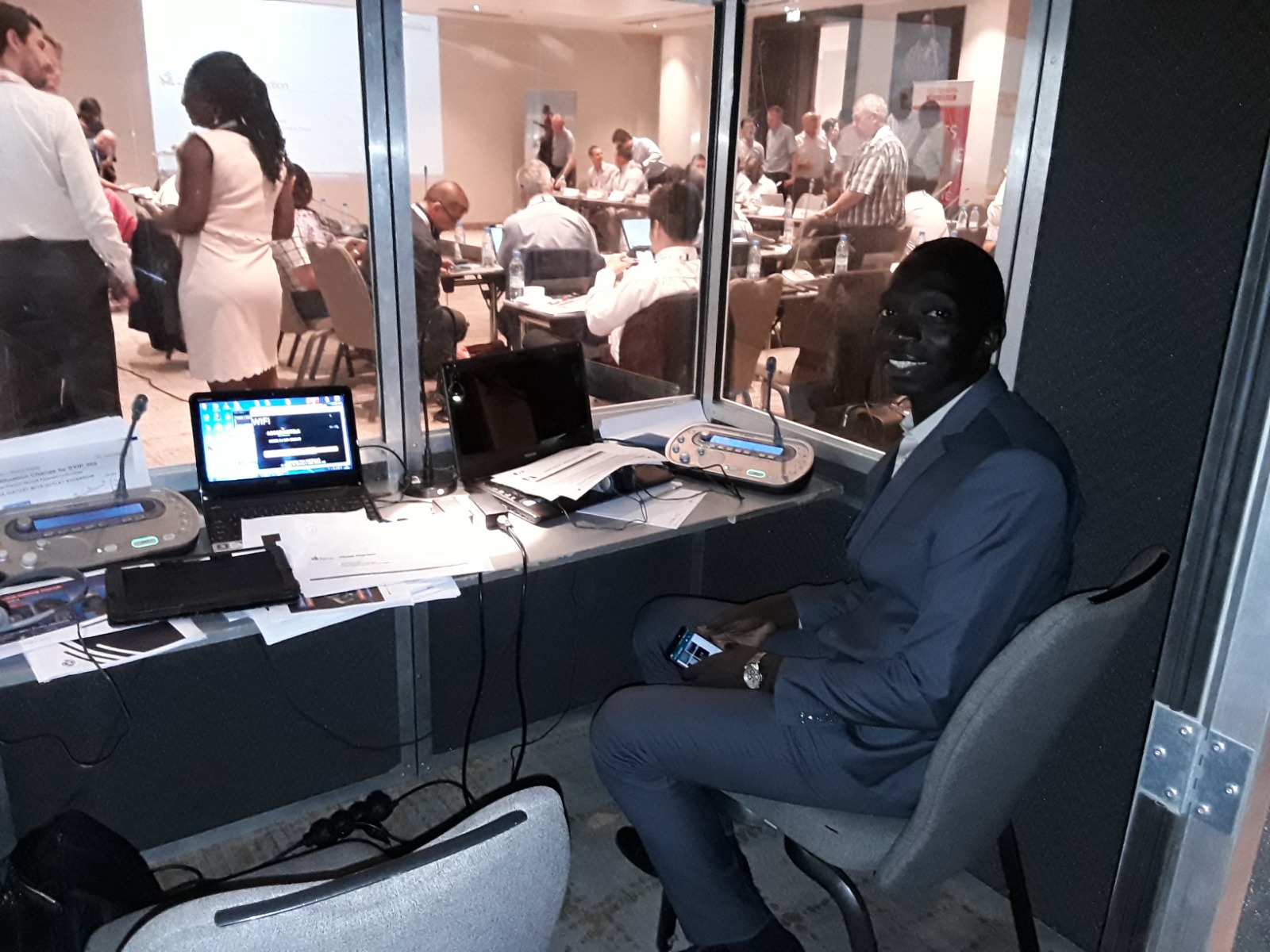 Interpreter in the booth with a view of the conference room